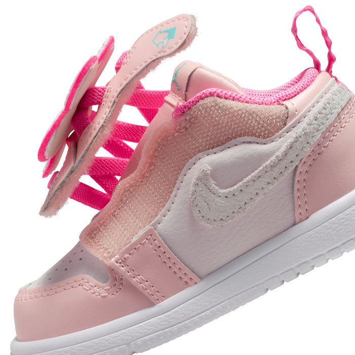 Side view of pink toddler low-top sneaker with gray Swoosh and hook-and-loop strap