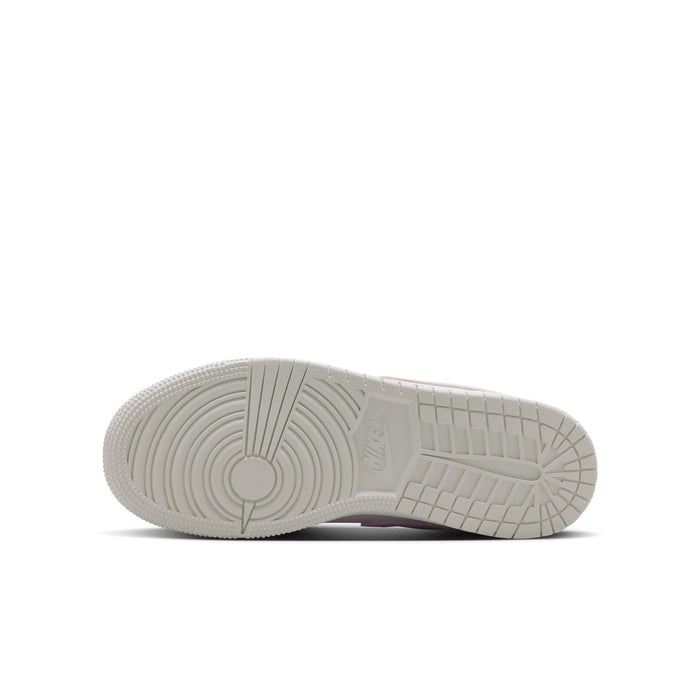 Youth sneakers outsole view with textured rubber tread on the light base