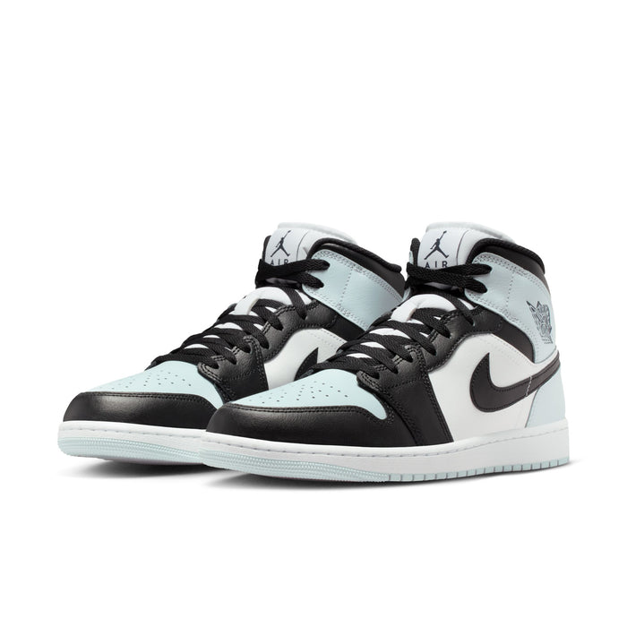 Pair of black, white, and light blue mid-top sneakers with Nike Swoosh and wings