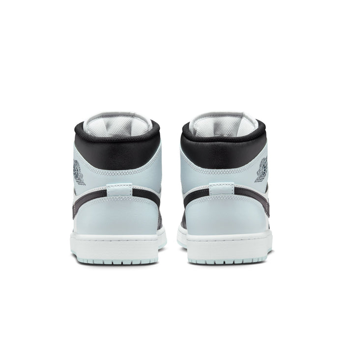 Back view of black and light blue mid-top sneakers with padded heel and white outsole