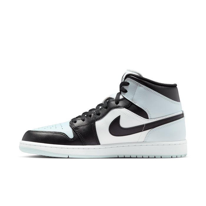 Side view of black, white, and light blue mid-top sneakers with lace-up and Swoosh