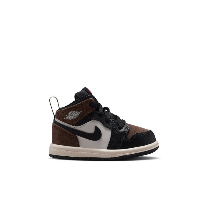 Toddler mid-top sneakers in black, brown, and white with Nike swoosh