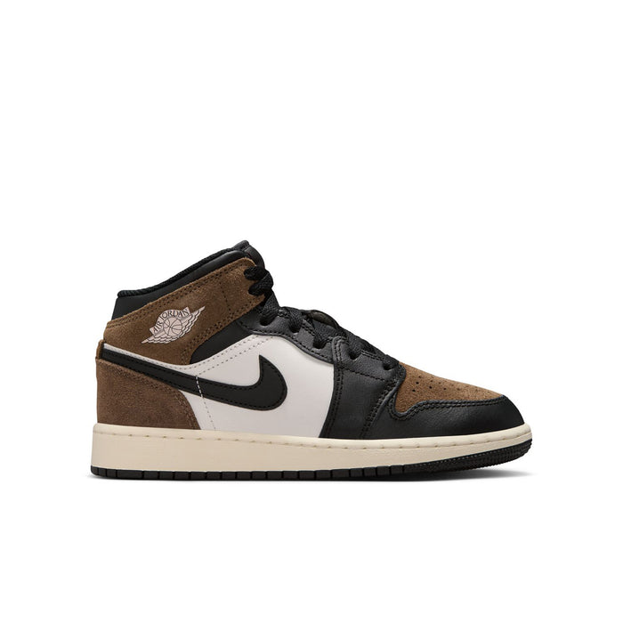 Youth mid-top sneakers with brown suede panels, black laces, white side, black swoosh.