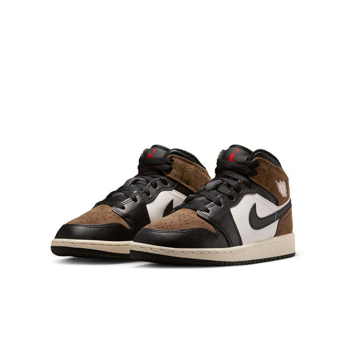 Pair of youth mid-top sneakers in brown suede, black and white with black Nike swooshes.