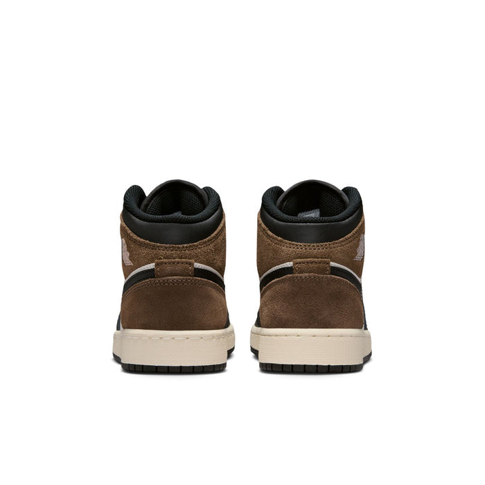 Youth mid-top sneakers heel view with brown suede back panels and white midsole.