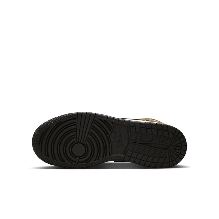 Black rubber outsole tread of youth mid-top sneaker.