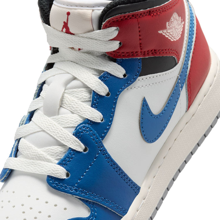 Youth Air Jordan 1 Mid sneakers close-up, white laces and blue Swoosh on leather upper.