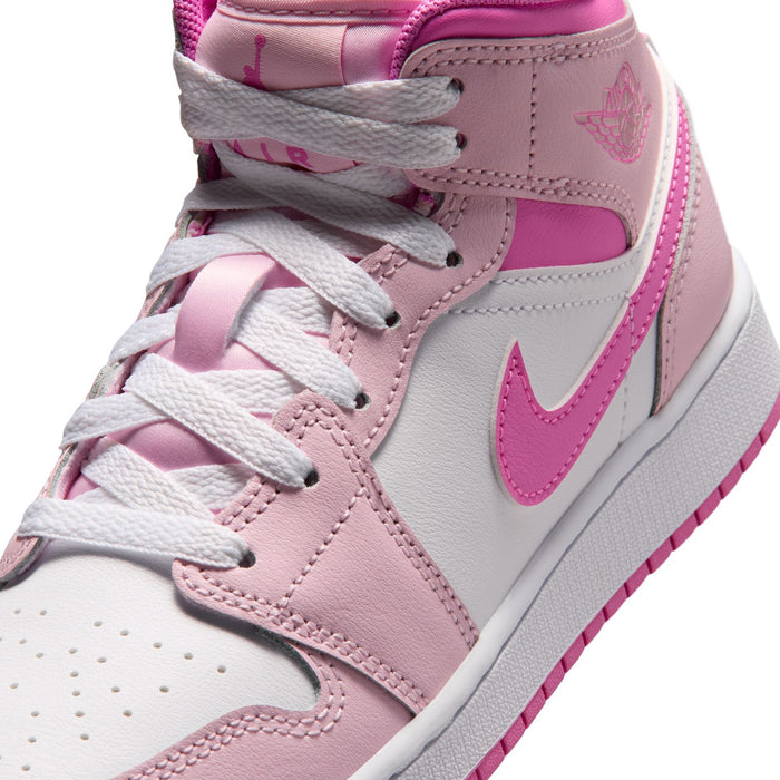 Close-up of youth sneakers showing pink laces, Swoosh, and stitched overlays