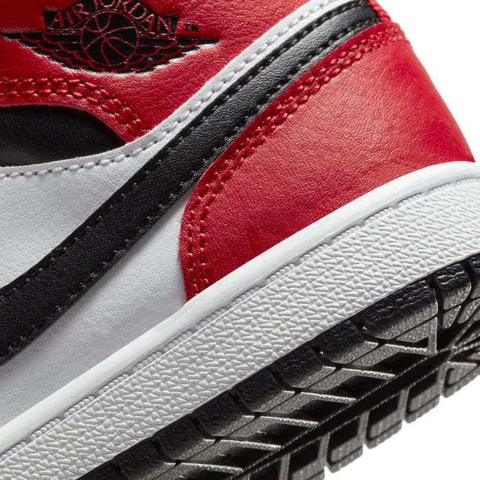 Kids sneaker detail with red upper, black trim, and Air Jordans outsole texture
