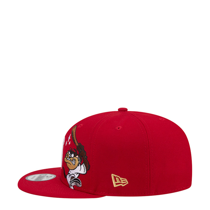 Red baseball cap with cartoon side character patch and small gold logo, snapback