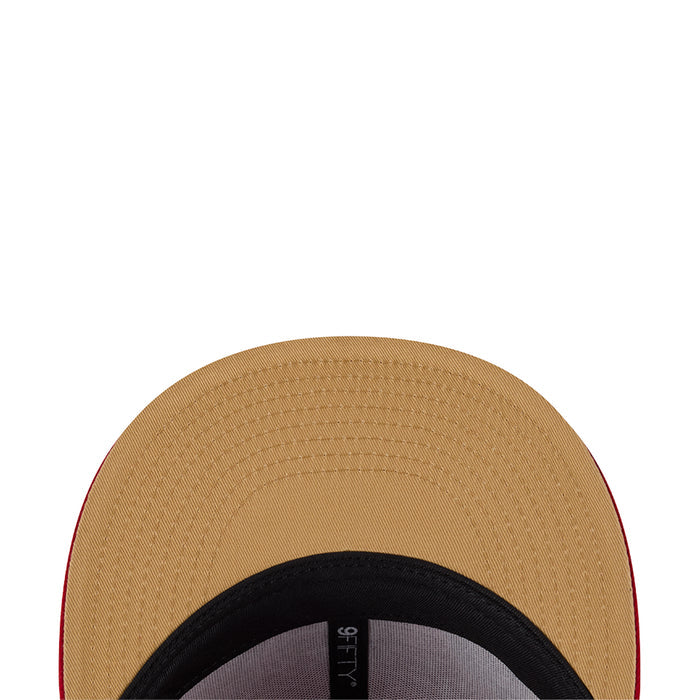 Tan baseball cap underside with black headband and gray fabric adjuster strap