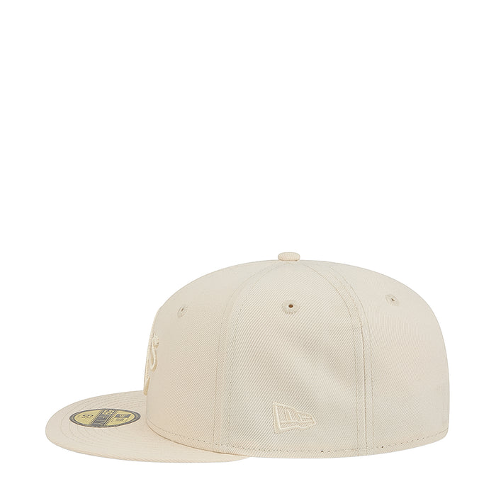 Light cream baseball cap with tonal emblem on front crown and curved brim