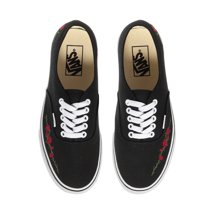 Women's black low-top sneakers with floral red rose embroidery and white lace-up front.