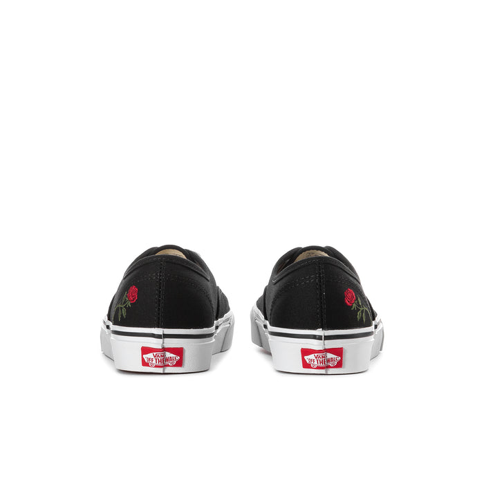 Women's black low-top sneakers heel view with red rose embroidery and white sole.