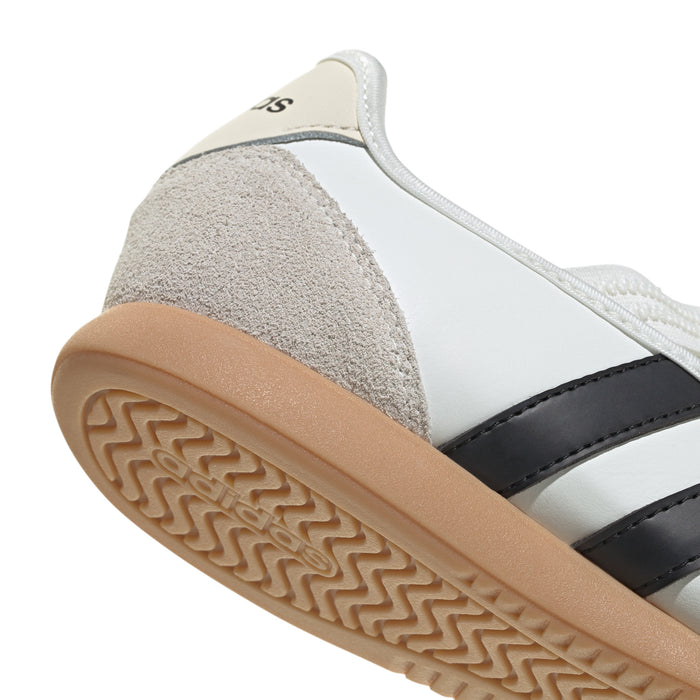 Women's Mary Jane sneaker outsole close-up, gum tread and black stripe accent