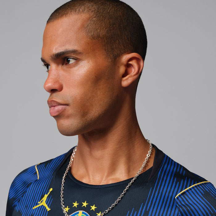 Men's Brazil away soccer jersey close-up with Brazil crest and gold Jordan logo on shoulder