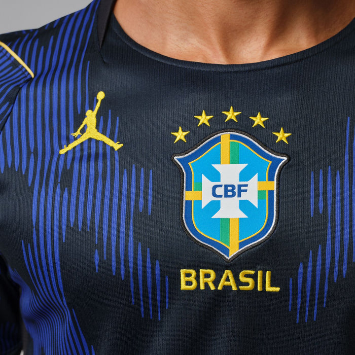 Brazil away soccer jersey chest panel with CBF crest, gold stars, and BRASIL lettering