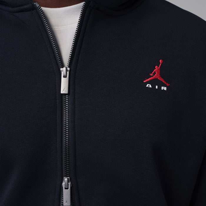 Black zip-up hoody chest detail showing red logo and metal zipper.
