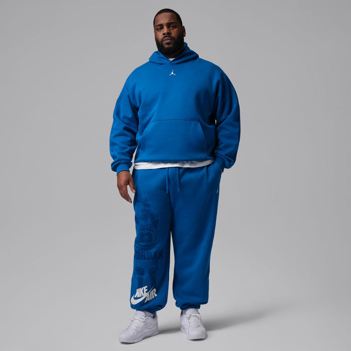 Men's blue cuff jogger pants with drawstring waist and large back graphic, full view