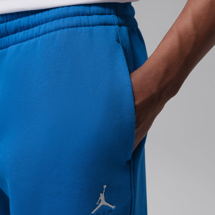 Men's blue cuff jogger pants with elastic waistband and small Jumpman logo detail