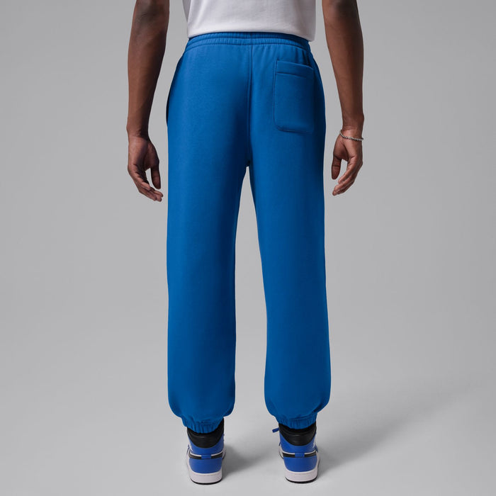 Men's blue cuff jogger pants with side pockets and elastic waistband, rear view