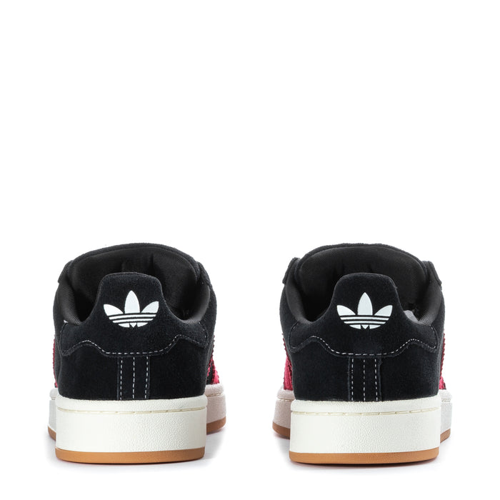 Men's black sneakers back view with white trefoil heel logo and red stripe accents