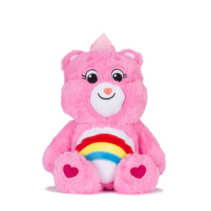 Pink plush backpack with cute bear face and rainbow belly detail