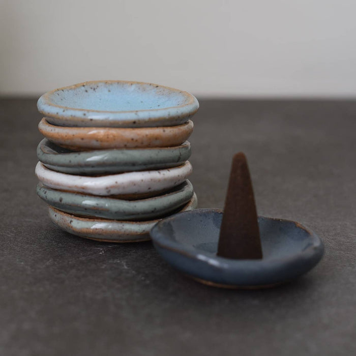 Ceramic incense cone holder dish with blue-gray saucer and dark cone