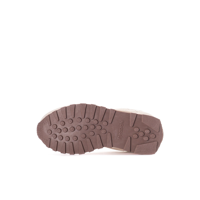Kids' Reebok sneaker outsole with brown tread and circular grip pattern