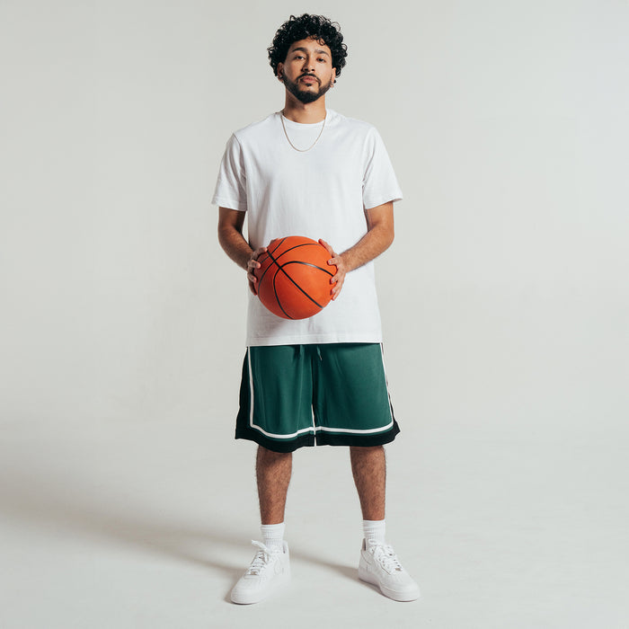 Men's green basketball shorts with white trim and black side panels, elastic waistband