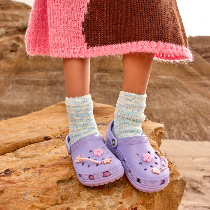 Kids light purple clogs with pink flower charms and light blue striped socks