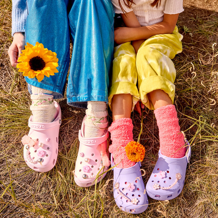 Kids light purple clogs with pink flower charms and colorful socks