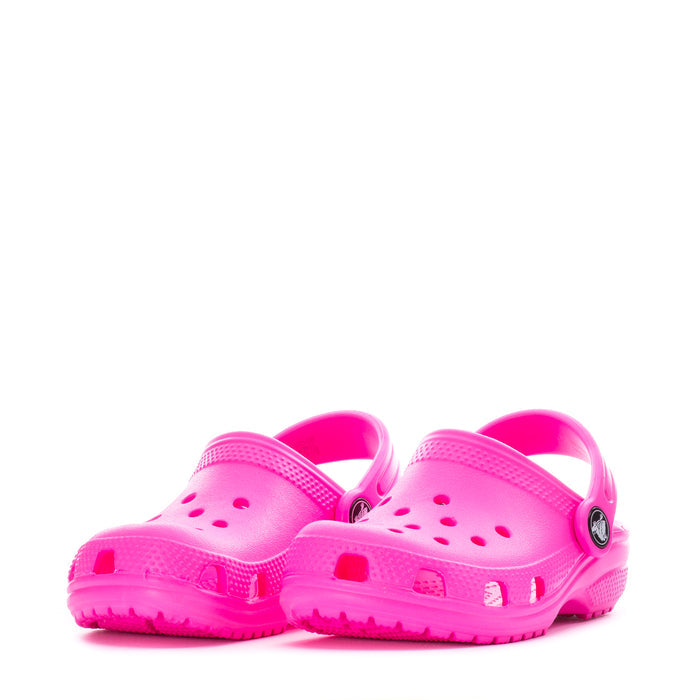 Pair of bright pink toddler clogs with circular logo and perforated toe vents.