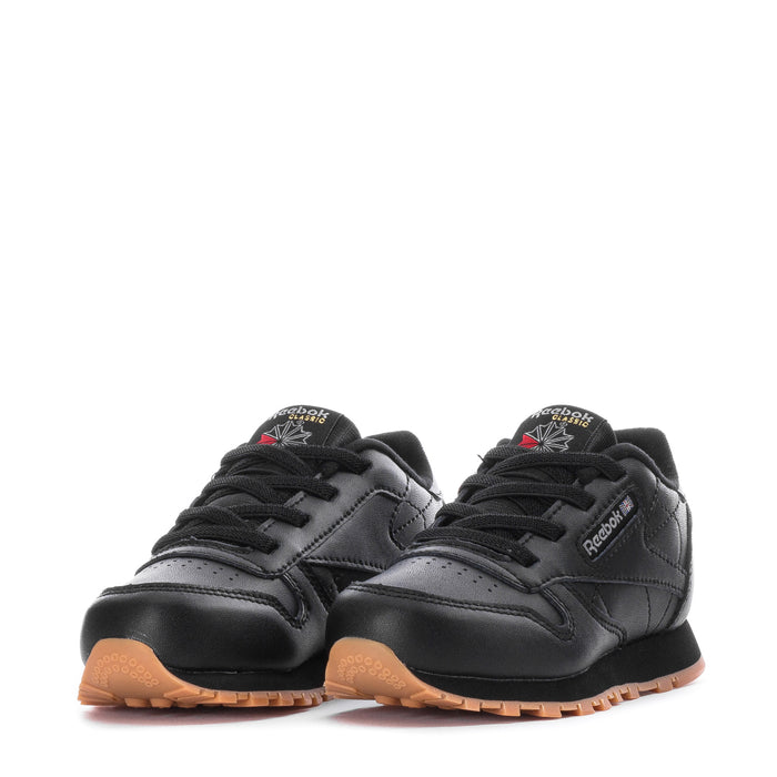 Pair of black toddler lace-up sneakers with gum soles and Reebok heel logos