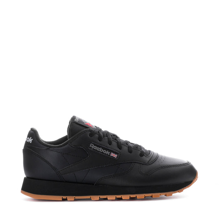Youth black leather sneaker with Reebok side logo and gum rubber outsole