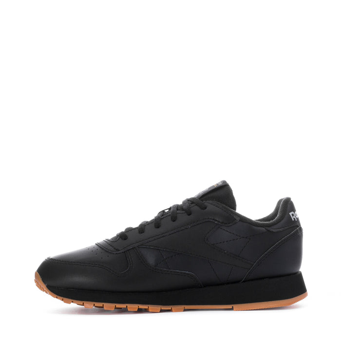 Youth black leather sneaker profile with lace-up front and gum-toned outsole