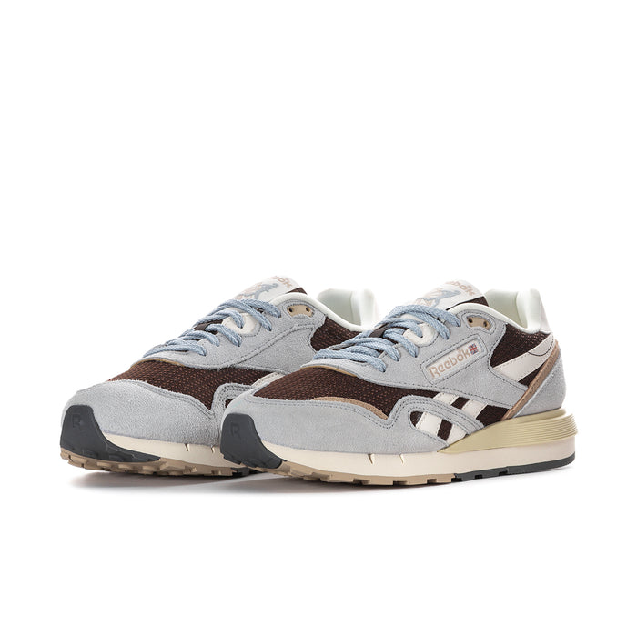 Women's Reebok sneakers side view, gray and brown panels with white stripes and blue laces