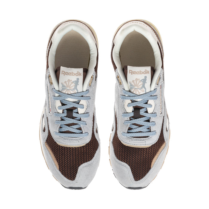 Pair of women's Reebok sneakers front view, blue laces, brown accents, white lining