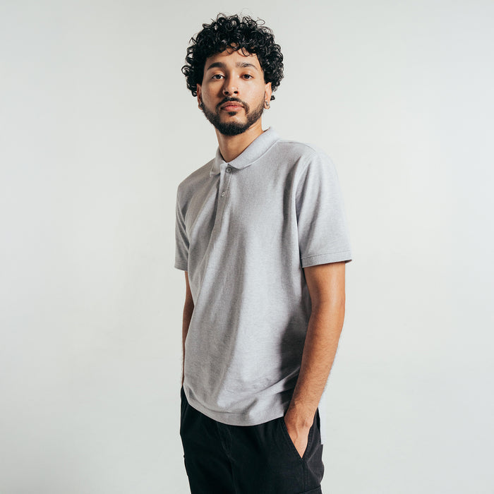 Men's heather grey pique polo shirt on model, short sleeves and collar