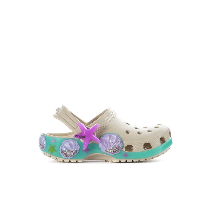 Toddler cream clog with teal sole, purple star accents, and side decorative charms