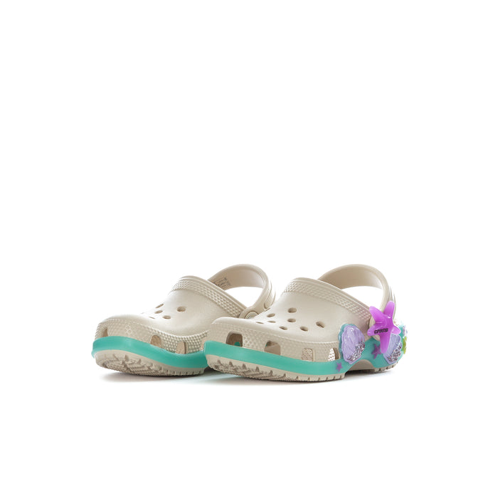 Toddler cream clogs with teal trim, back strap, and purple bow-style decorative pieces
