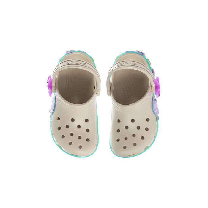 Toddler cream slip-on clogs with ventilation holes, purple accents, and teal-edged lining