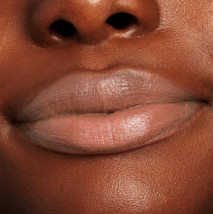 Lips wearing ColourPop Lippie Stix in Cookie, a warm nude beige shade, shown in a tight close-up lip swatch on a model, highlighting smooth, even coverage for everyday wear.
