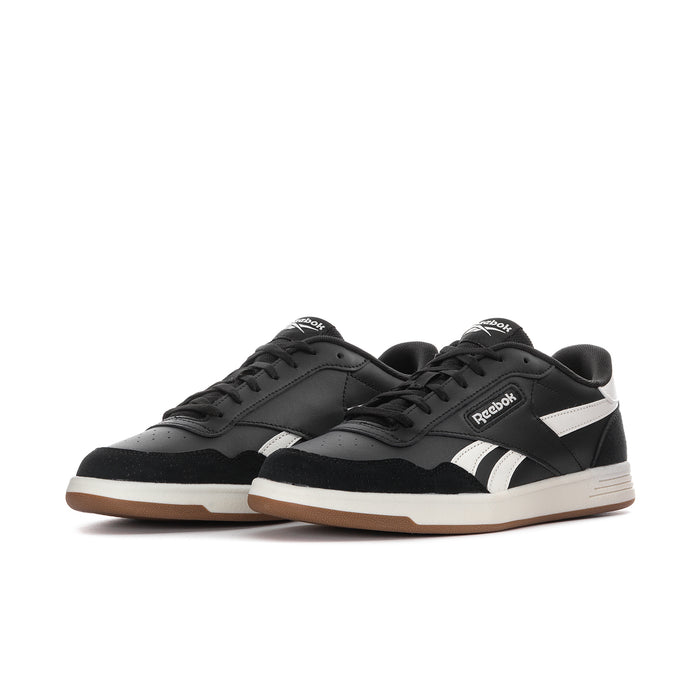 Men's Reebok low-top sneakers, black uppers with white side stripes, gum outsole
