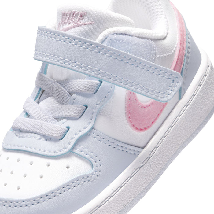 Close-up toddler Velcro strap and laces, white with pink swoosh and blue stitching