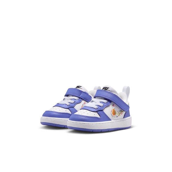 Toddler low-top sneakers, white and blue, side view with colorful graphic detail