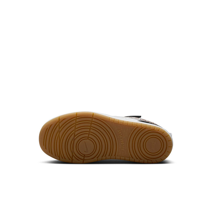Kids sneaker outsole with tan rubber tread under white and black upper