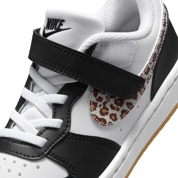 Kids sneaker upper close-up: white laces, black strap, and leopard print swoosh