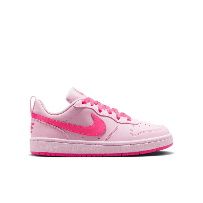 Youth pink low-top sneakers with pink swoosh, lace-up front, and white sole