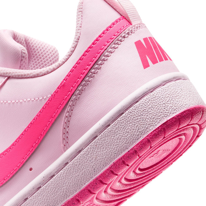 Youth pink sneaker side and outsole close-up with NIKE branding and textured tread